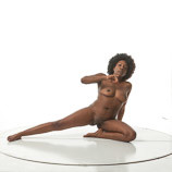 Nude black female in a seated art reference pose