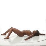 Nude black female in a reclining art pose for sculptors and painters