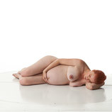 Sculpture reference photo of nude pregnant female laying on her side