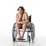 360 degree views of a nude female art model with spina bifida posing in her wheelchair