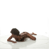 African-American female art model crawling on her stomach