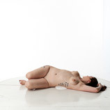 360 degree rotatable images of a nude female artist's figure model with an average build laying on the floor