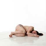 360 degree rotatable images of a nude female artist's figure model with an average build laying on the floor