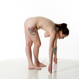 360 degree rotatable images of a nude female artist's figure model with an average build in a standing pose bent over with her legs crossed