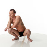 360 degree rotatable images of a slim male art figure model squatting