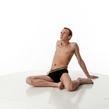 360 degree rotatable images of a slim male art figure model sitting on the floor