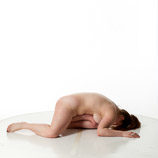 Artist reference photos of a nude curvy full figured female figure model posed kneeling and laying on the floor