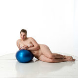 Artist reference photos of a nude curvy full figured female figure model posed with an exercise ball