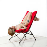 360 degree rotatable artist reference photos of a slim nude blond female art model posed with a sling chair