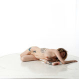 360 degree rotatable artist reference photos of a slim nude blond female art model posed laying on the floor