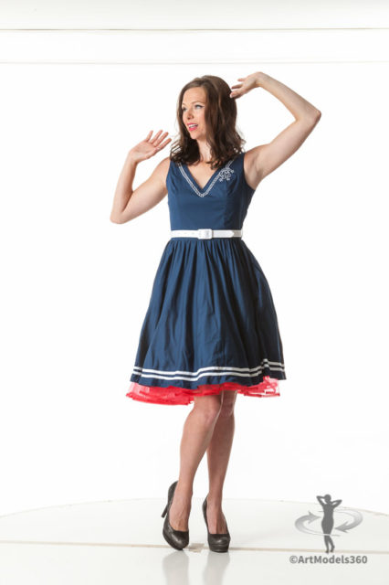 Fine art pinup model in a blue dress and a classic pin-up pose